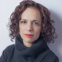 Judith Matloff, with curly hair and wear a black sweater.