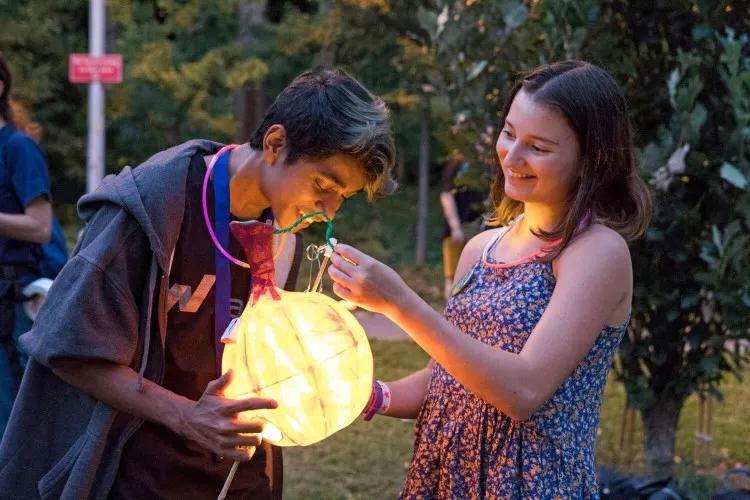 two children playing with lantern light