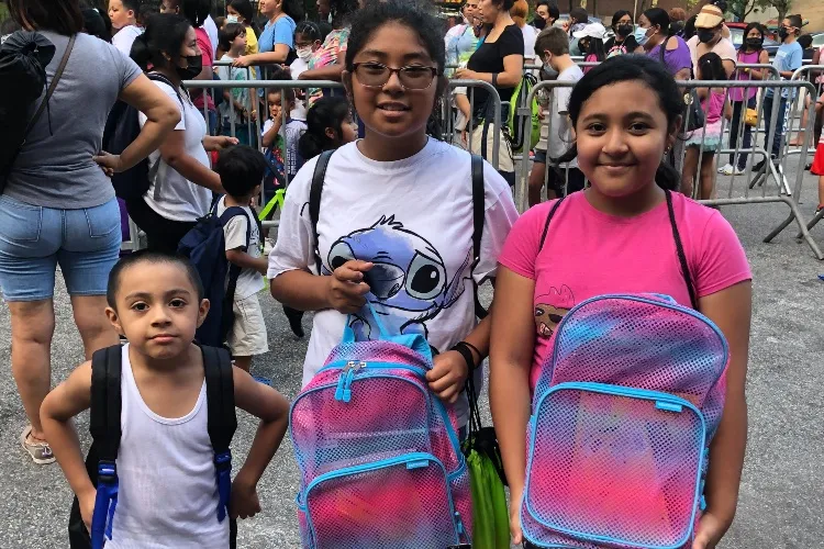 three children and backpacks