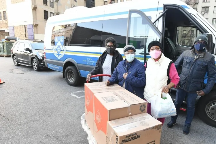 Facilities and Operations staff members safely deliver pre-Thanksgiving meals to local senior citizens. Photo Credit: Eileen Barroso