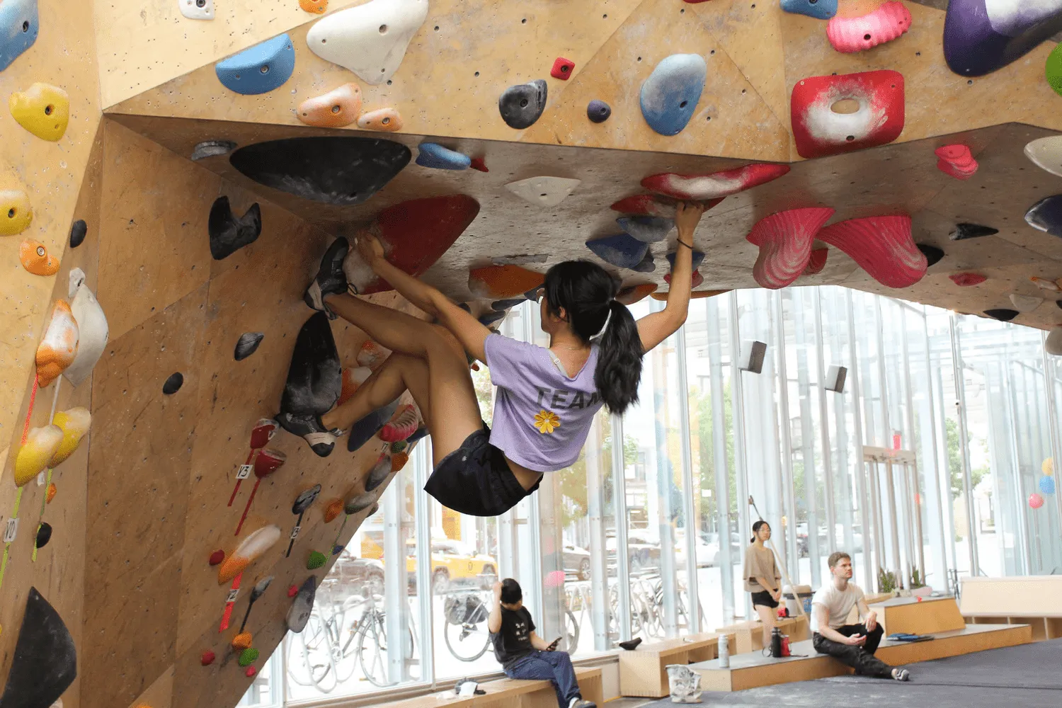 A person climbs a rock wall at VITAL.