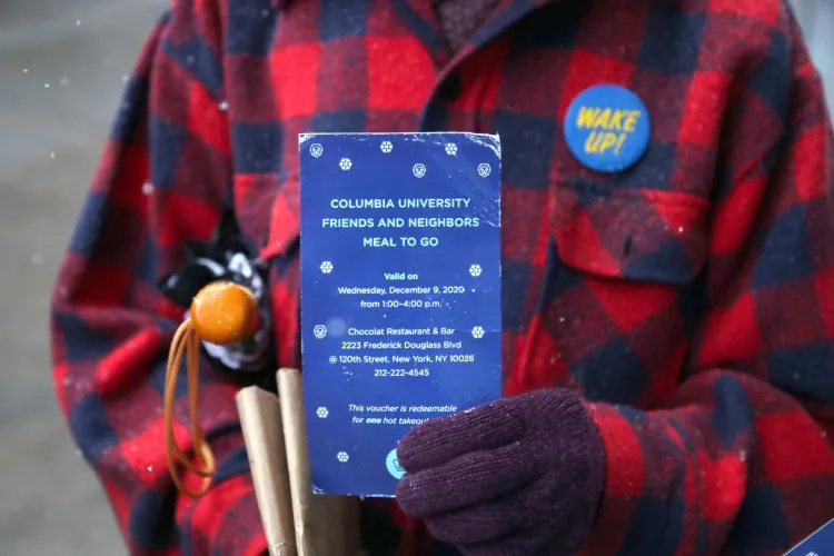Individual holding food voucher