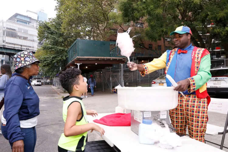 Youngsters enjoyed sweet cotton candy treats at the 10th Annual 'Back-2-School' Block Party in Harlem. Photo Credit: Michael DiVito