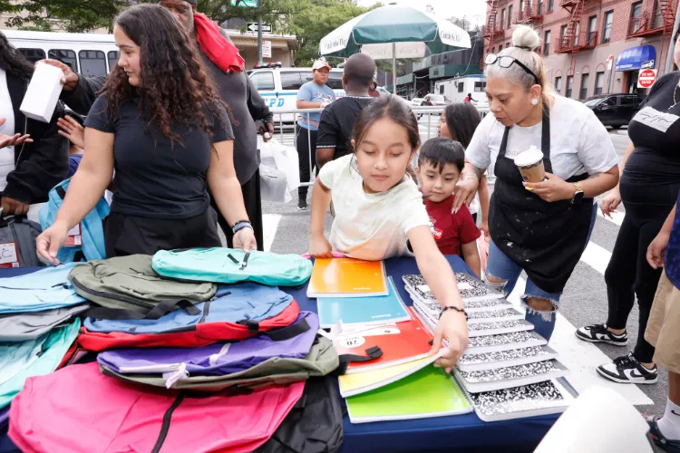 Local youth received backpacks packed with school supplies at the back-to-school block party. Photo credit: Michael DiVito