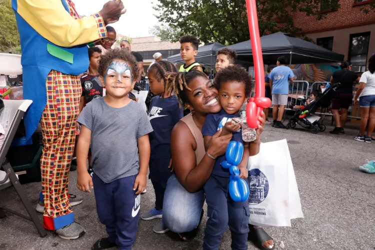 Attendees enjoying the 10th Annual 'Back-2-School' Block Party in Harlem. Photo Credit: Michael DiVito