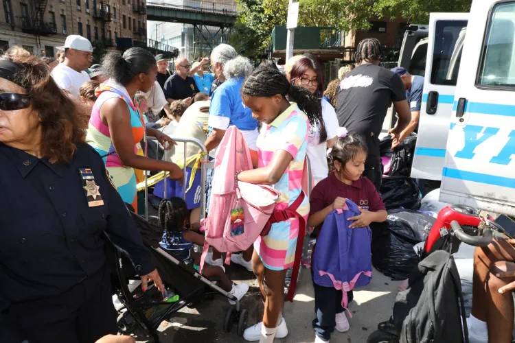 Hundreds of backpacks filled with school supply essentials were distributed to local youth at the 11th Annual "Back-2-School" Block Party in Harlem. Photo credit: Michael DiVito