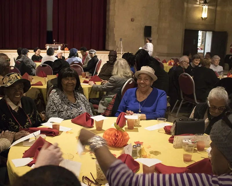 Smiling guests at the Senior Thanksgiving Luncheon at Riverside Church