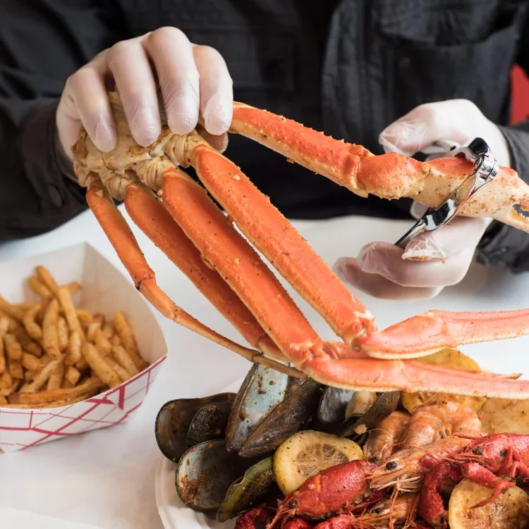 Person with a crab at Cap't Loui in West Harlem