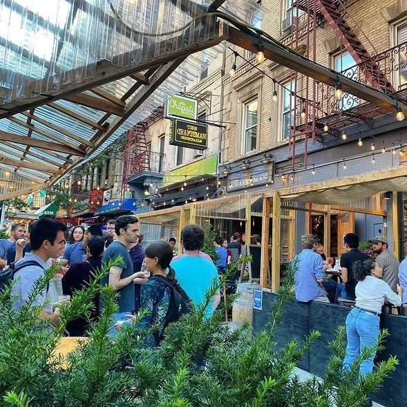 People enjoying themselves outdoors at The Craftsman in West Harlem.