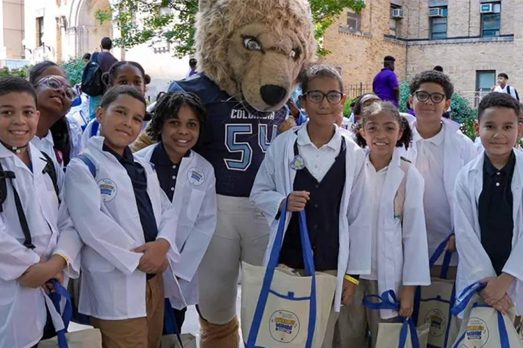Kids pose with Roar-ee in stethoscopes and white coats.