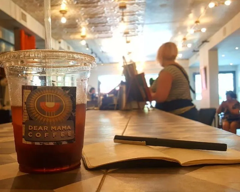 Iced coffee, a journal, pen and customer