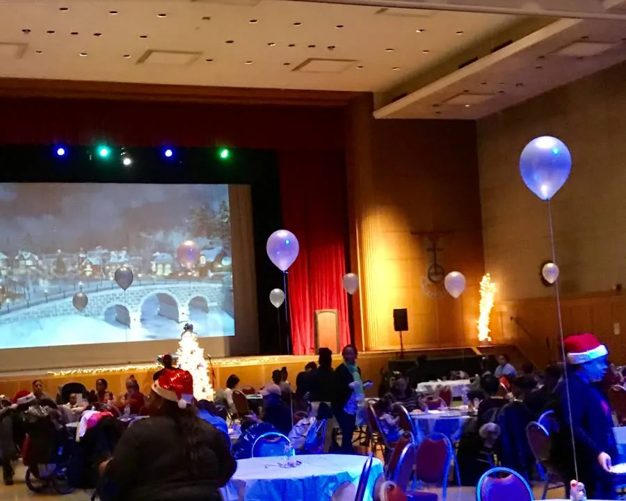 Tables and participants at the holiday gathering