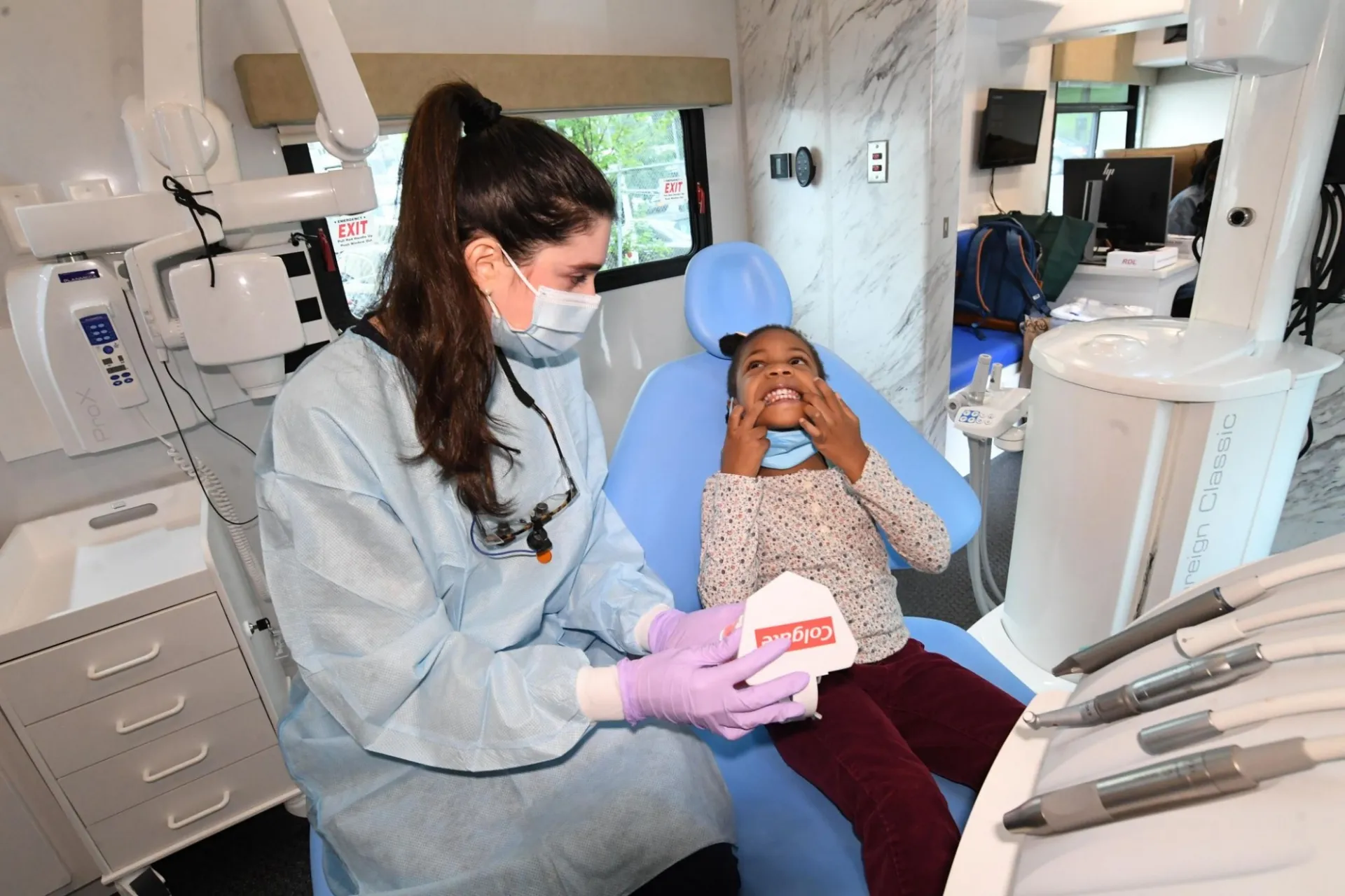 A happy smiling customer in the dental van. 