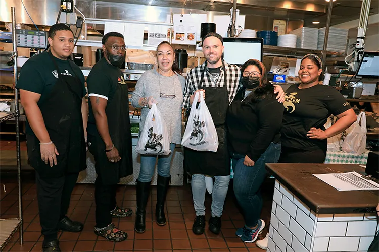 Employees at Dinosaur Bar-B-Que prepare grab-n-go meals for neighbors. 