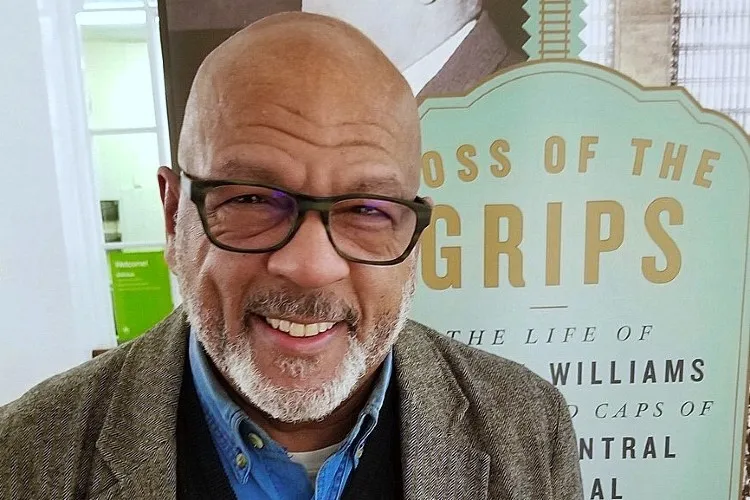 Eric K. Washington stands in front of a sign for his new book.