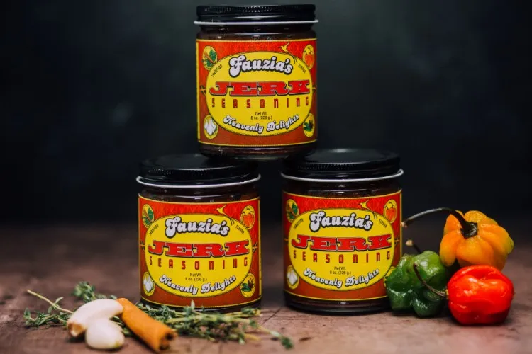 Three jars of jerk seasoning against a plain background