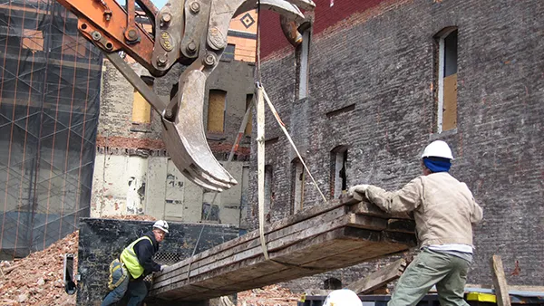 A construction crew preserving long leaf pine during a building demolition at the Columbia University Manhattanville development site