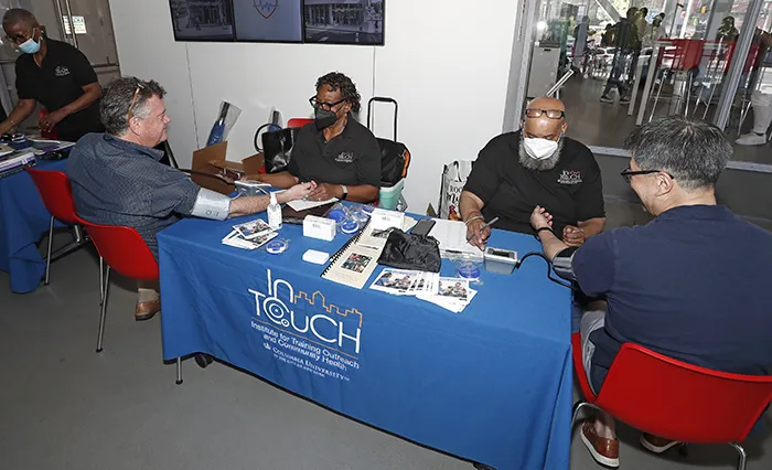 Two InTouch volunteers do blood pressure screenings in The Forum. 