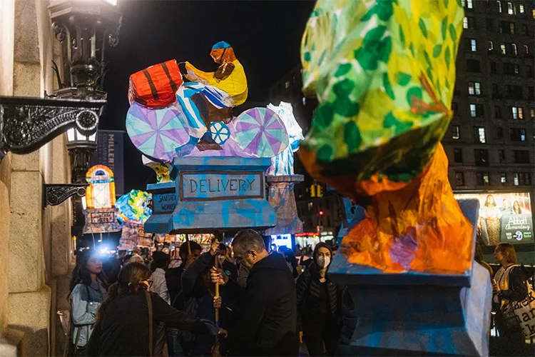 Lantern-bearers walk down Broadway. 