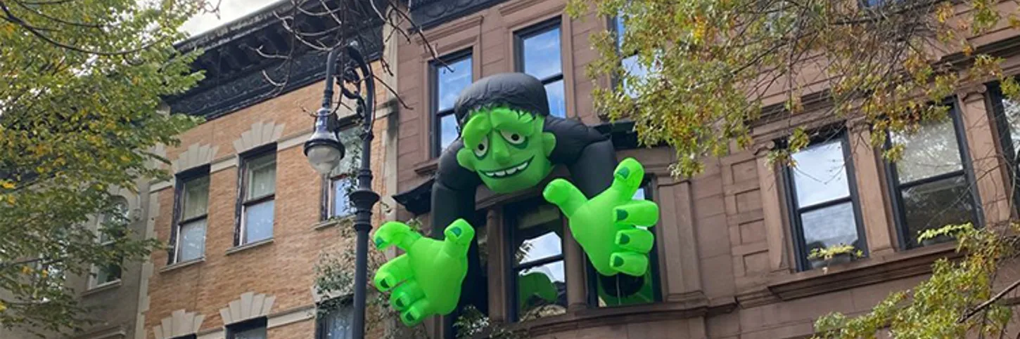 monster sticking outside of building