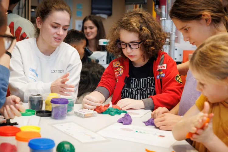 A group of youth learning about the different elements of neuroscience through a hands-on activity at the Saturday Science workshop. Photo credit: Sirin Samman
