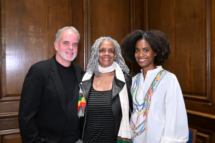 One man and two women pose for a photo, looking at the camera. 