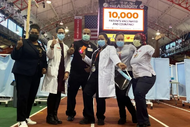 Group of practitioners posing for a photo inside the armory. 