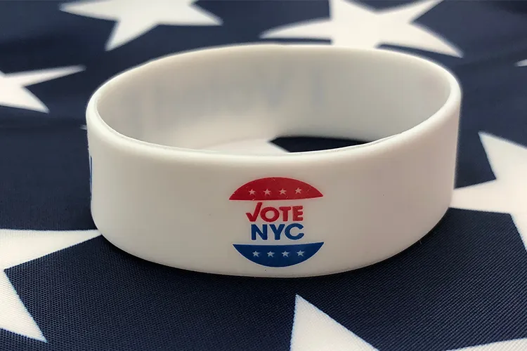 A Vote NYC wrist band on a flag.