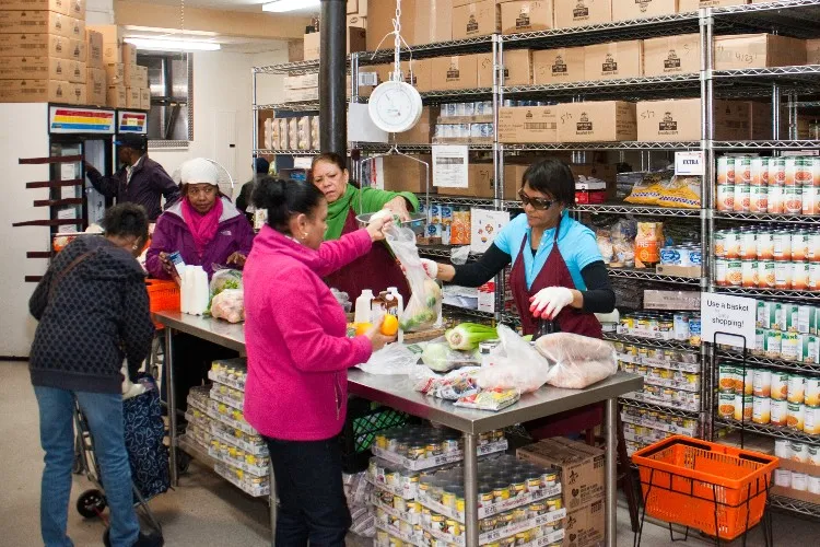 Group of people bagging food for distribution. 